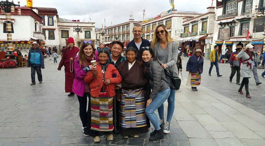 Tibetan Pilgrims holding Hand-held prayer wheels in Barkhor Street